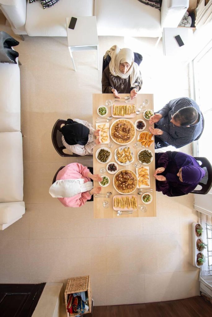 Family eating together with multi generation members in modern living room