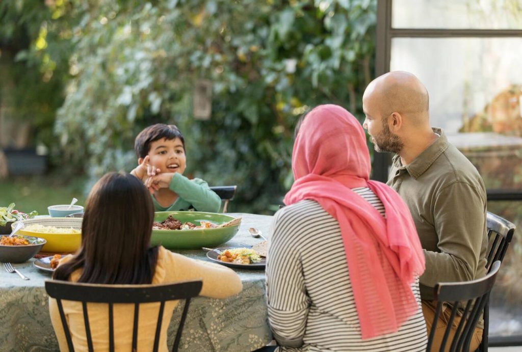 Pakistani family enjoying a traditional meal together in a warm and friendly setting