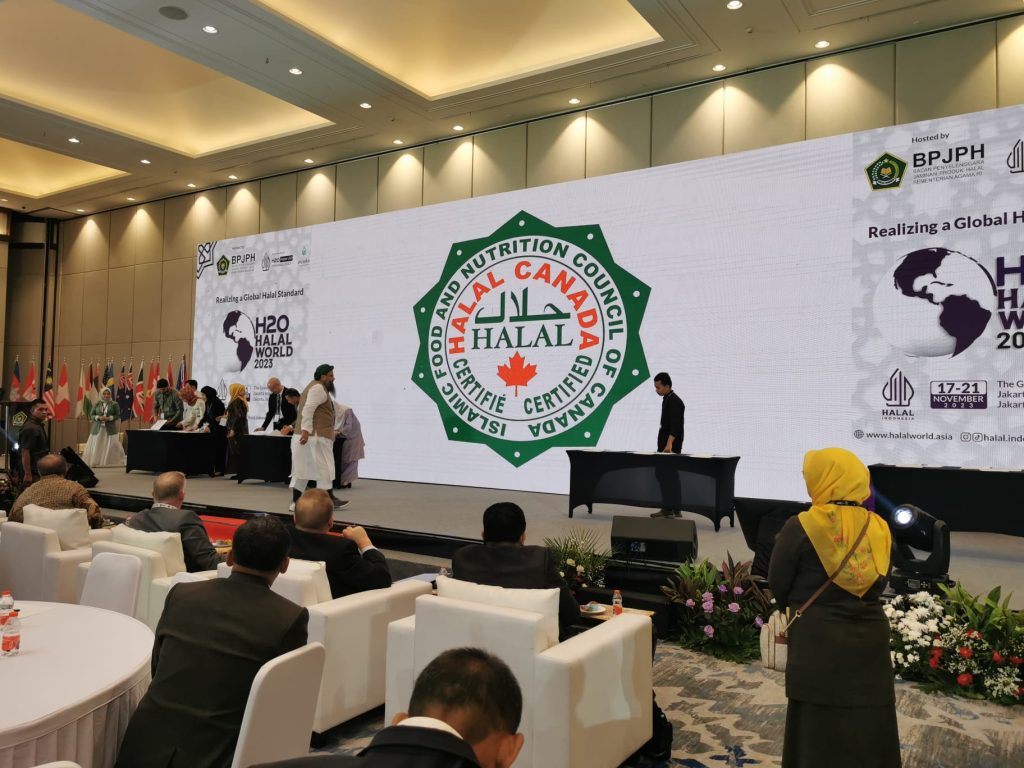 The IFANCC Canada logo displayed on a large screen at the H2O Halal World 2023 conference, highlighting its role as an international halal certification provider recognized by bodies like BPJPH.