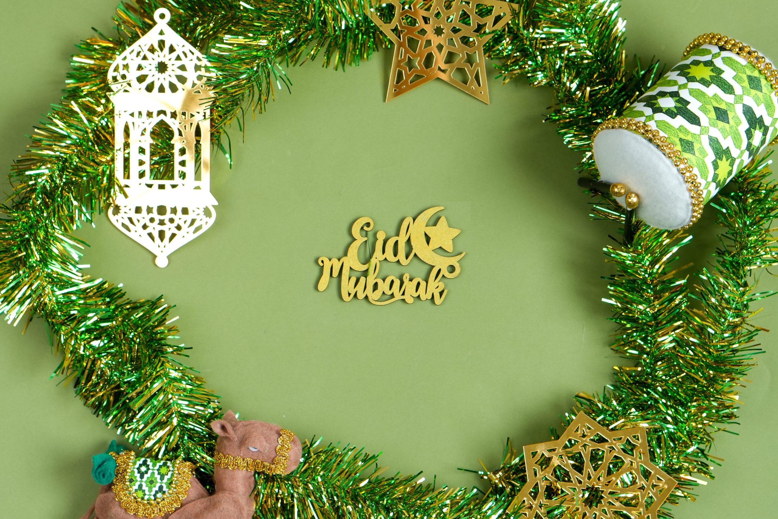 Flat Lay Of Eid Mubarak Word In The Middle With Islamic Decoration On Green Sage Background A celebratory Eid Mubarak greeting with traditional decorations