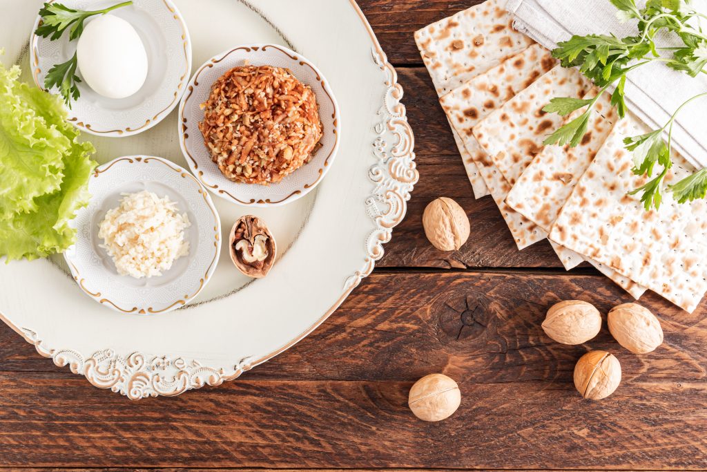 A beautiful dish with festive food for the Jewish Passover holiday. matzoth, nuts, lettuce, parsley, fruit paste. 