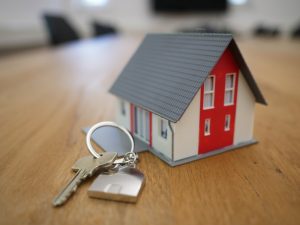 House key beside a model home representing halal home financing in Canada