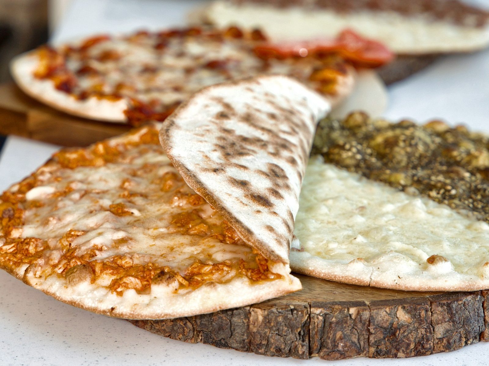 Freshly baked cheese zaatar and meat manaeesh at Sahtein Bakery