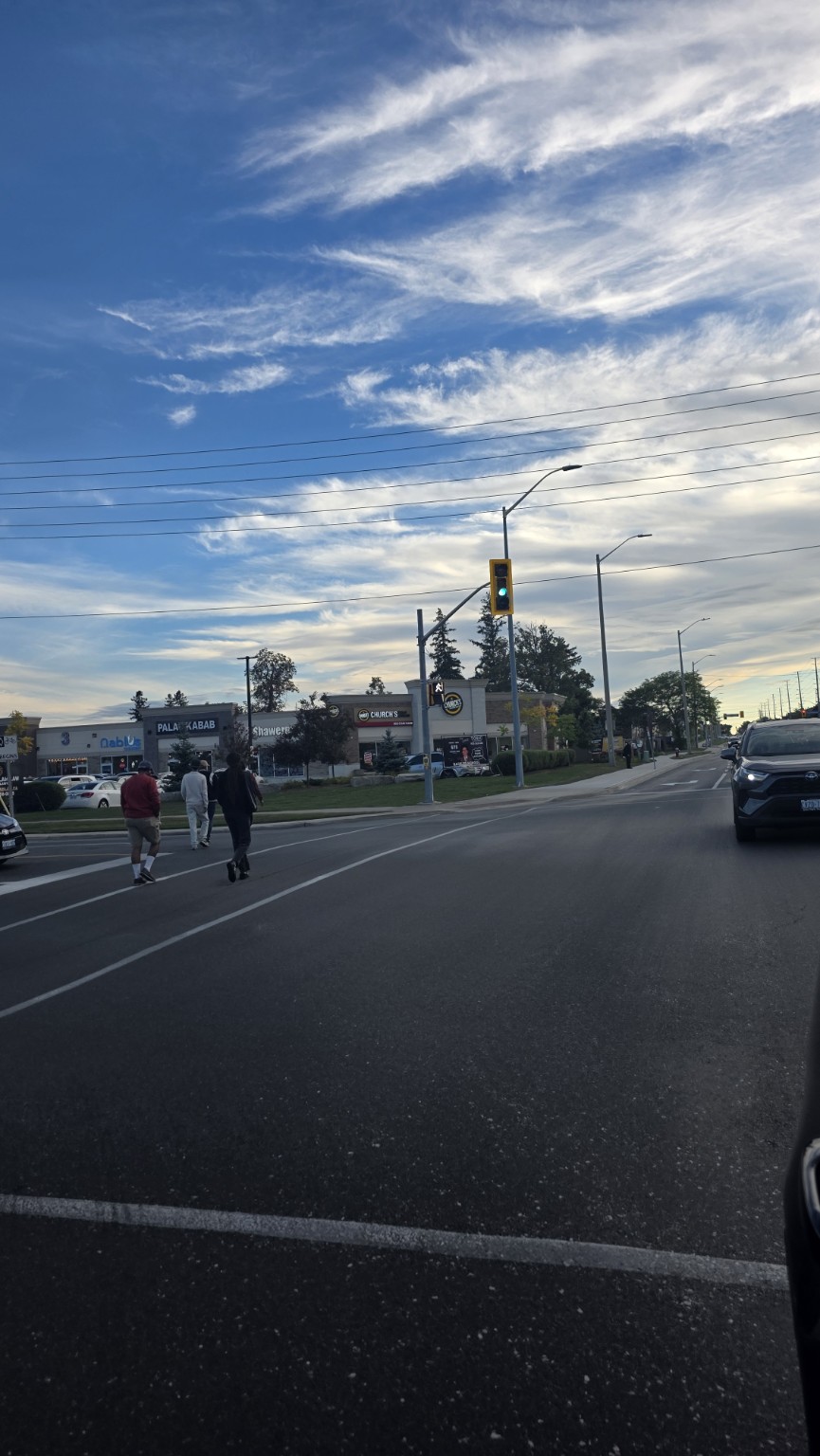 Pedestrians crossing the road near Ridgeway Plaza in Mississauga