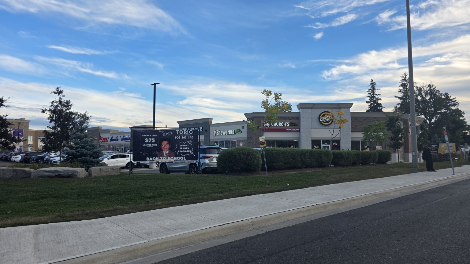 Ridgeway Plaza storefronts and parking seen from the street in Mississauga