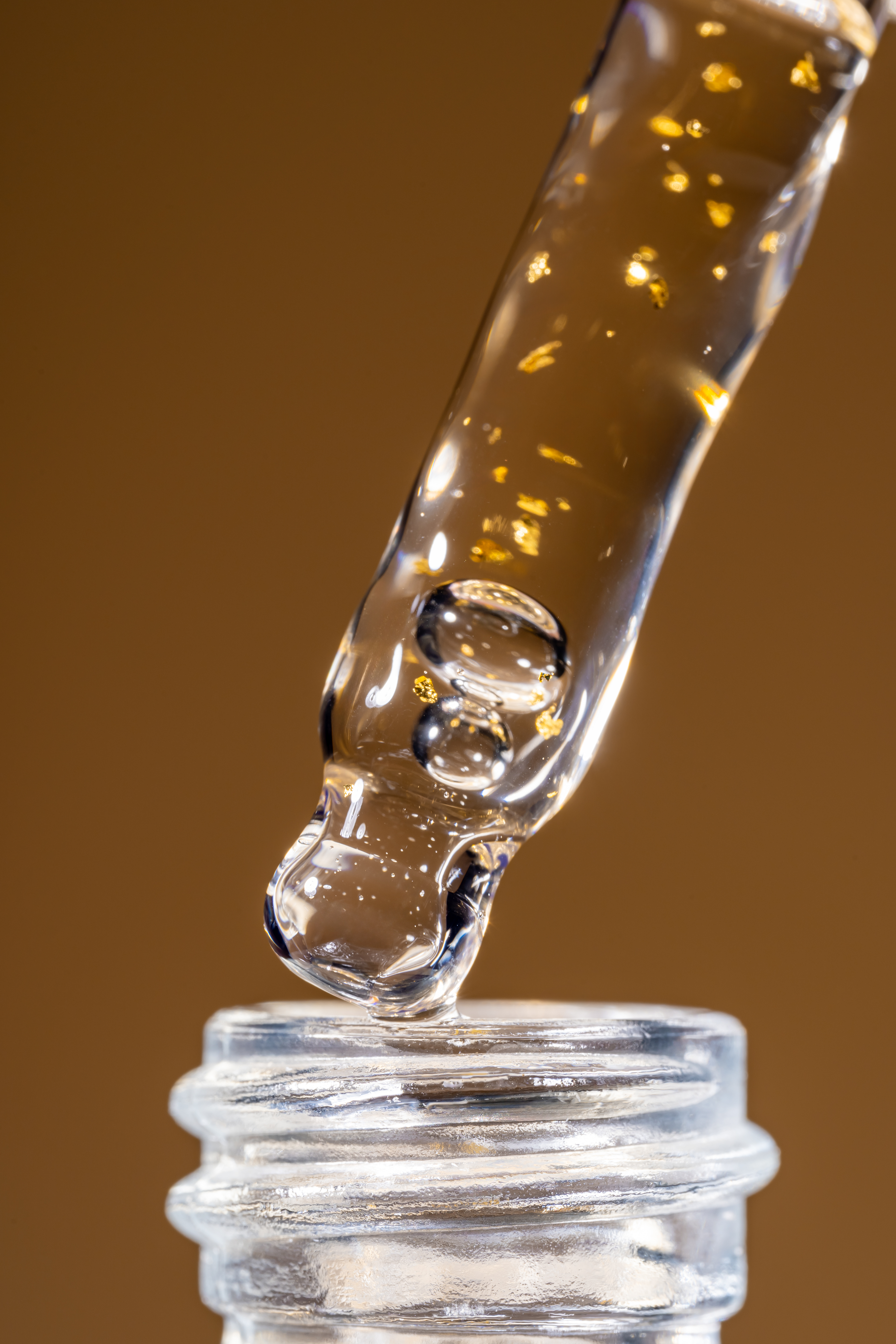 Dropper dispensing a liquid formula into a bottle
